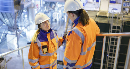 Employees talking at plant